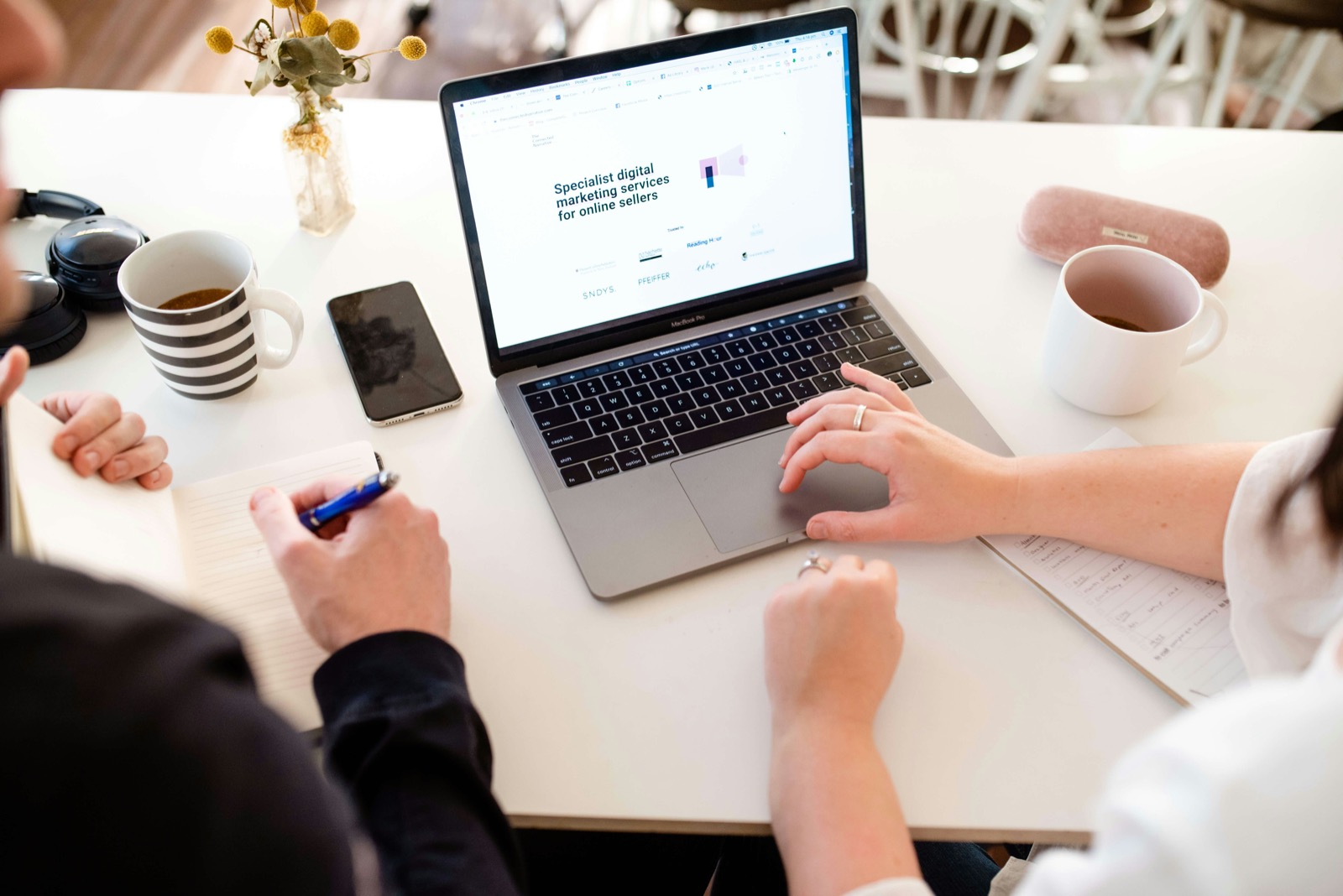 Twee mensen werken samen achter een laptop